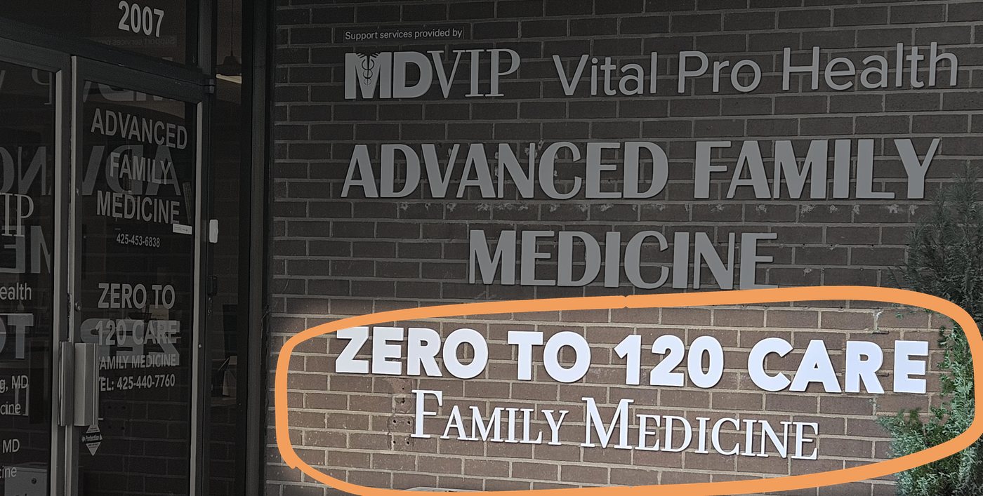 Entrance of 2007 152nd Ave NE: glass doors and a brick wall with the Zero to 120 Care Family Medicine sign